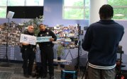 Police officers stand in library holding signs