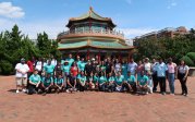 New international students and OIR staff posing for a picture in front of Norfolk's Pagoda and Oriental Garden