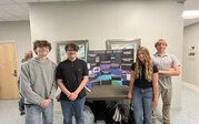 MAC team – Zamory, Zachary, Ellis, Carter, Amelie with their research poster and rocket.