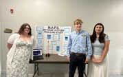 M.A.P.S. team – Kelly, Ella, and Connor with their research poster and rocket.