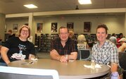 the people smiling at a table