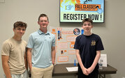  No Hands team – Alex, Jacob, and Caiden with their research poster and rocket.