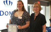 person accepting award and posing with mentor