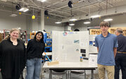 Solar Explorer team – Kavya, Fiona, and Karter with their research poster and rocket.