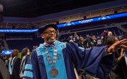 President Brian O. Hemphill, Ph.D., waves to students as he exits the the College of Arts and Letters commencement on May 6. Photo Chuck Thomas/ODU