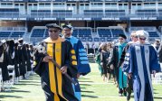 A photo of Austin Agho with the University Mace.