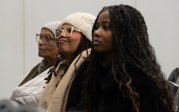 Alicia Peoples (center) and others listen to speakers at Old Dominion University’s 41st Annual Martin Luther King Jr. Observance in the Big Blue Room at Chartway Arena.