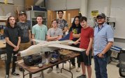VSGC student group in UAV Lab with an original airframe now modified for RC-only testing