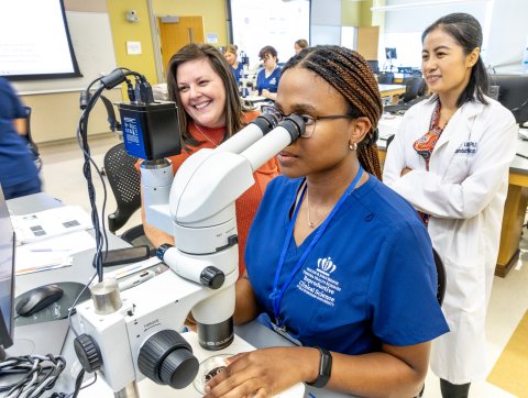 Student observes embryos under a microscope
