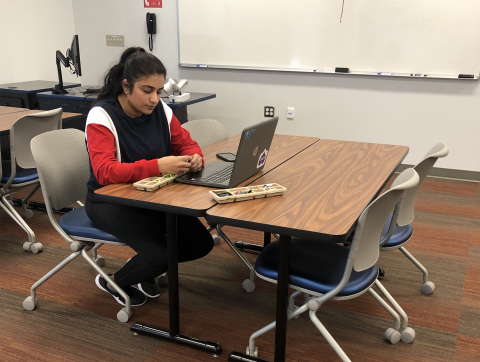 Student uses laptop and other STEM equipment.