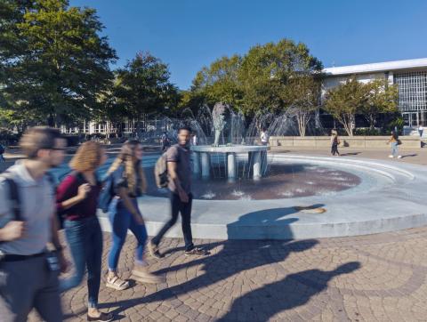 Students walking in front of fountain