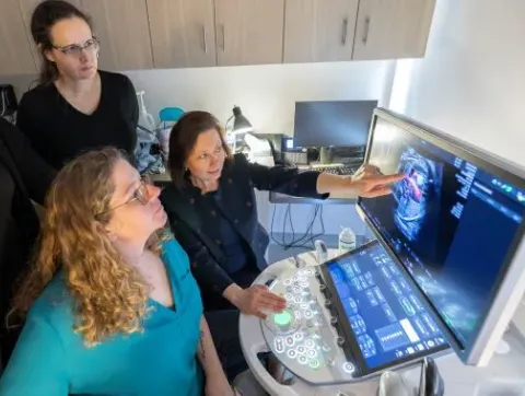 instructor demonstrating something on a laptop to student in