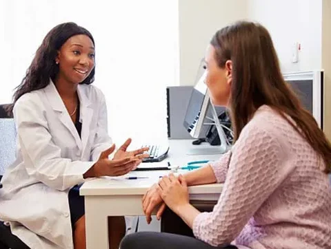 A physician talks with a clinical trial participant.