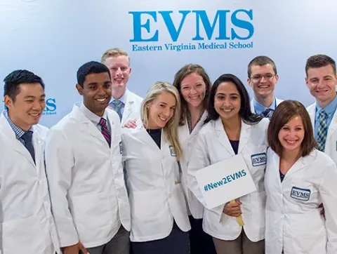 A group of new EVMS students pose for a photo during new stu