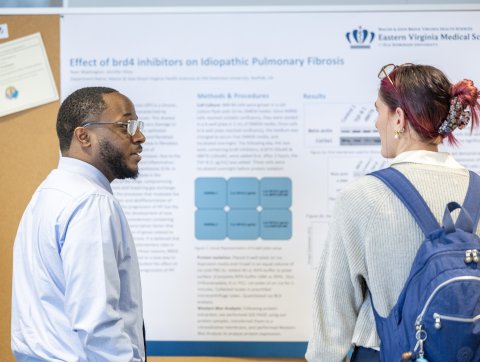 Students chatting at a research expo