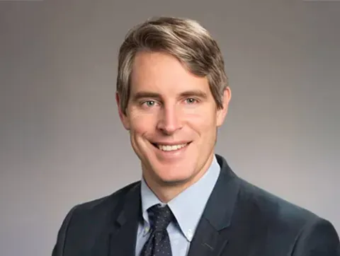 Dr. Goudy had short graying light brown hair, is wearing a d