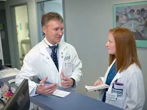 Dr. Ronald Flenner talks with a student.