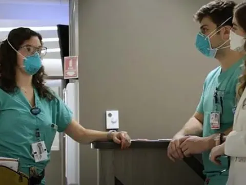 Anastasia Samaras, MD, a psychiatry resident, speaks to a ma