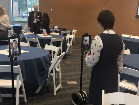 Student uses mobile telepresence robot for virtual meeting.