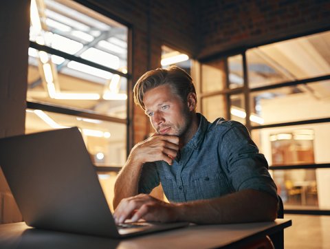 Young man on a laptop in a modern setting