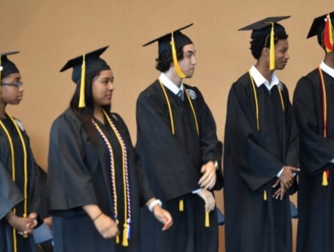 Image of trio students in graduation attire