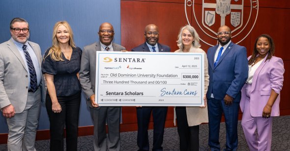 ODU and Sentara Healthcare representatives pose with a large bank check for $300,000 made out to the Old Dominion University Foundation.