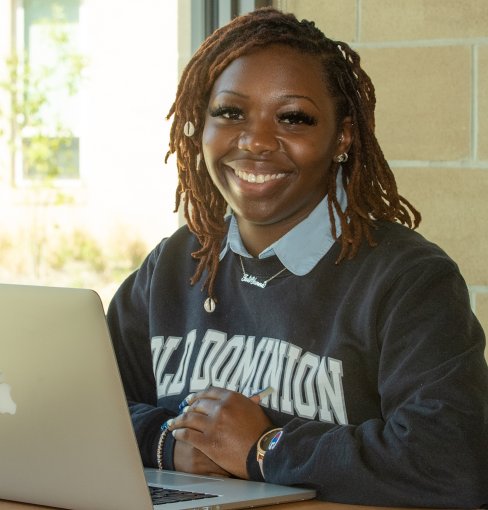 Tati'Yanna Thompson sitting with computer