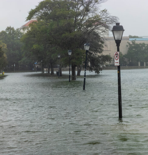 Street lights are surrounded by flood waters. 