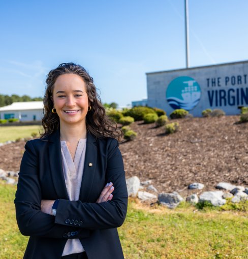 Finley Stoops stands in front of Port of Virginia sign. 