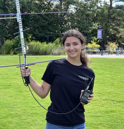 McKenzie Denton poses with radio antenna on ODU campus