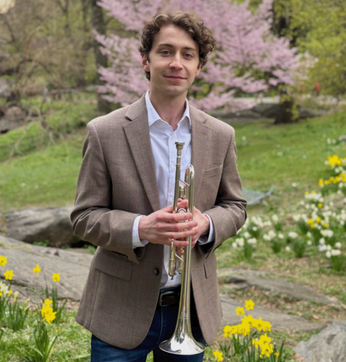 Taylor Hubbard holding his trumpet.