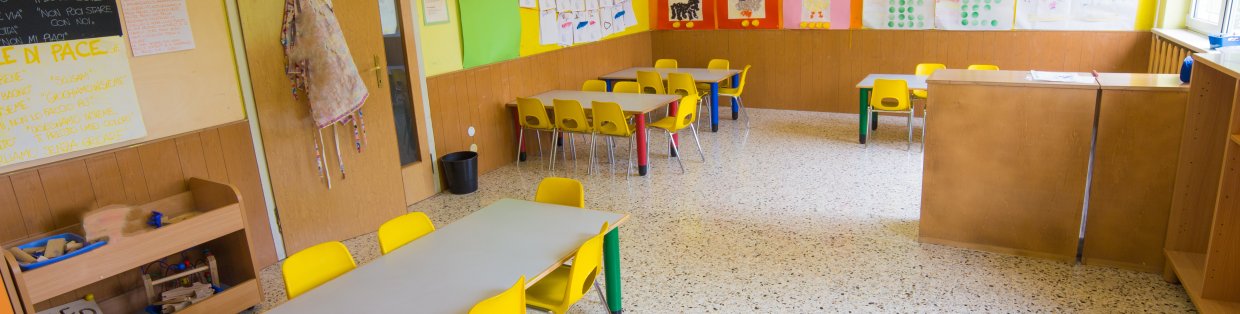 Kindergarten classroom with tables and chairs.