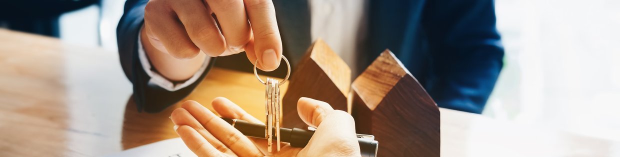Person giving house keys new buyer