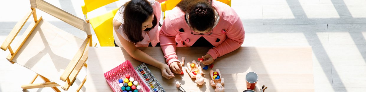 A teacher working with a student on blocks