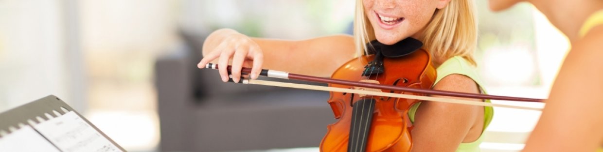 A student learning how to play the violin. 