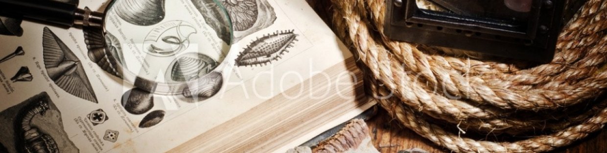 a book of herbology next to some rope and lit candle.