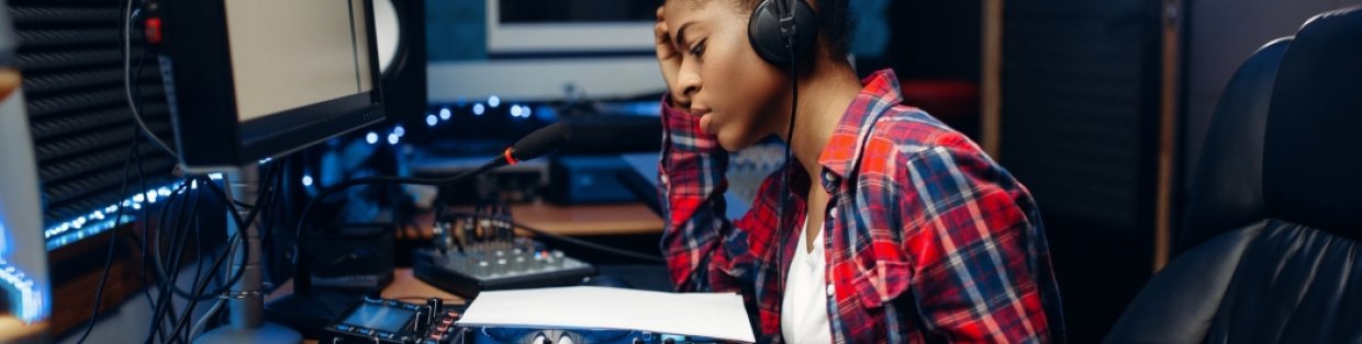 A person wearing headphones inside a sound room.