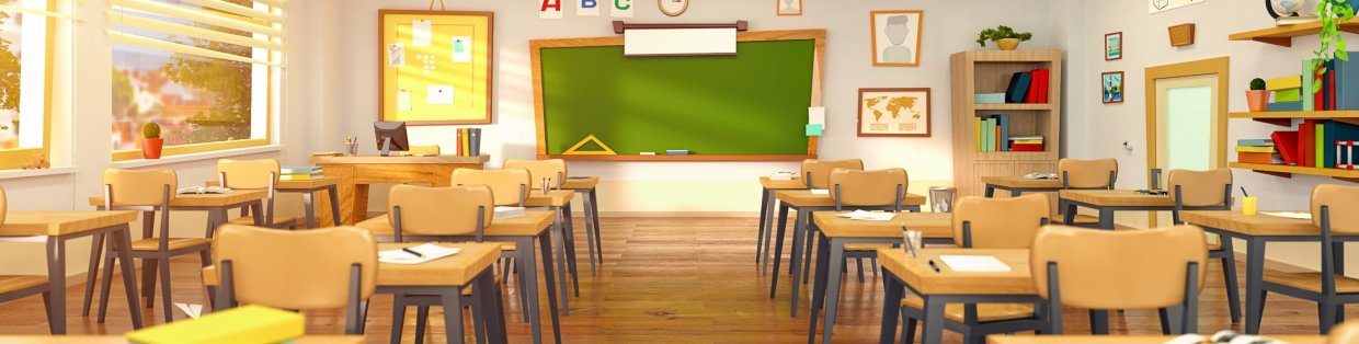 Empty classroom with chalkboard and yellow hued lighting. 