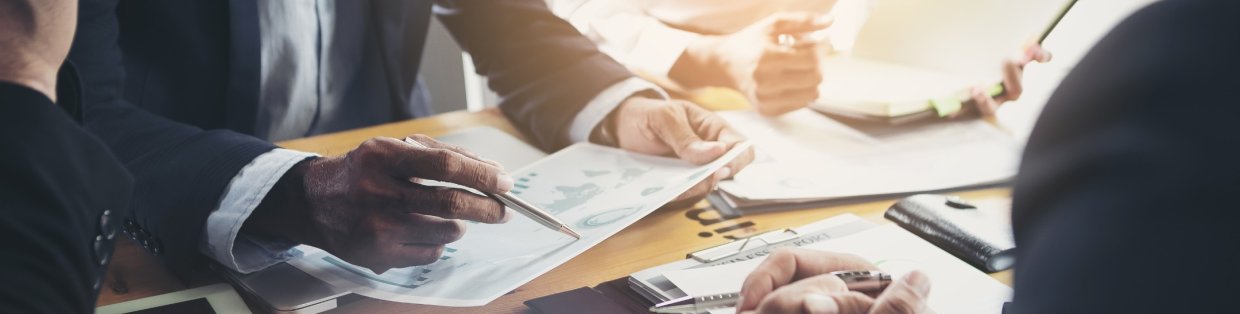 Close up visual of hands looking over documents and charts.