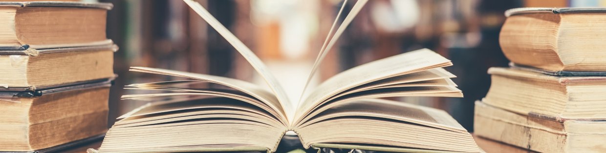 An open book with a person flipping through the pages. 