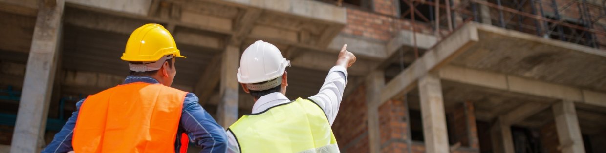 construction works on site wearing hard hats.