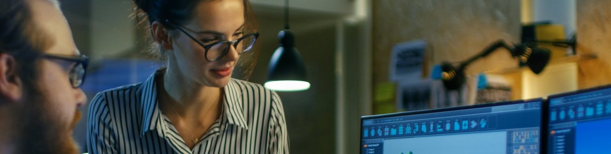 A person wearing glasses looking intense at documents. 