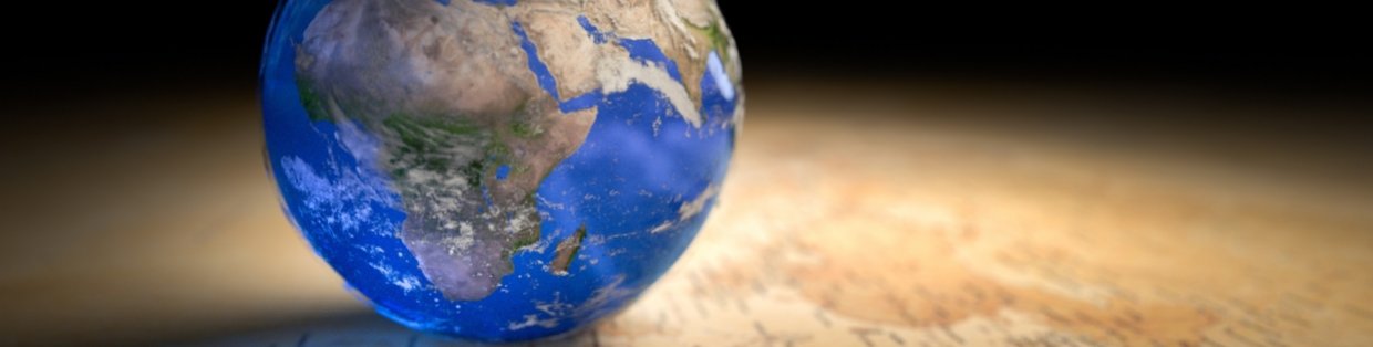 Globe on top of a hard surface that's casting a reflection. 