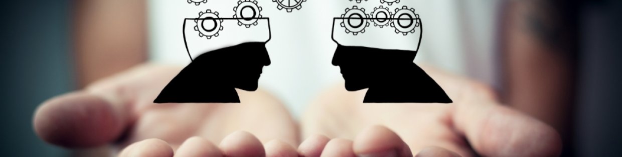 Two hands reaching out and cupping a digital image of two heads sharing thoughts. 