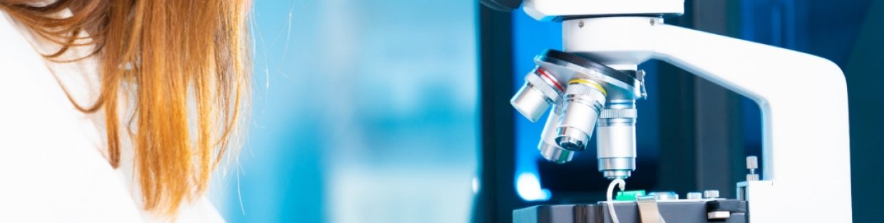 student using microscope