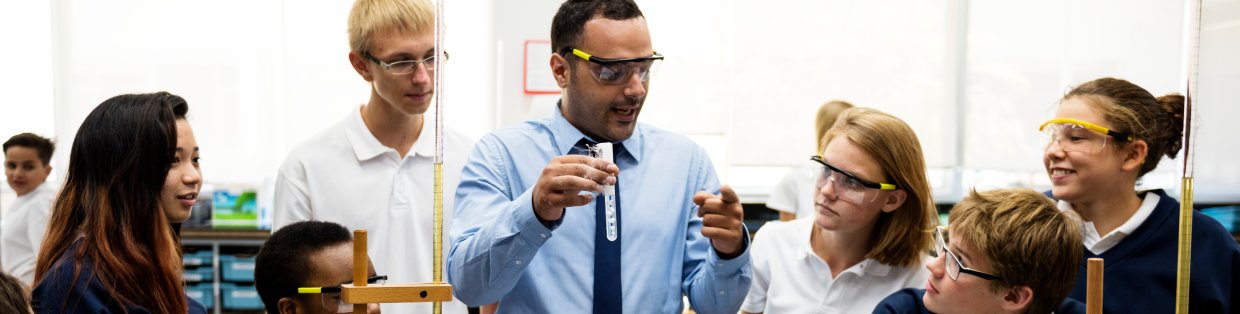 A teacher teaching science to students.