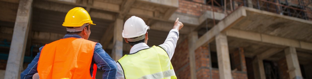 construction works on site wearing hard hats. 