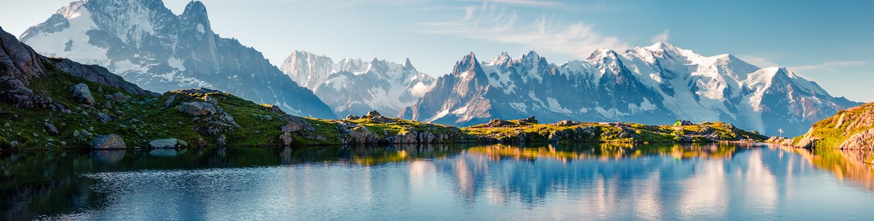 outdoor scape of a crisp clear lake surrounded by mountains. 