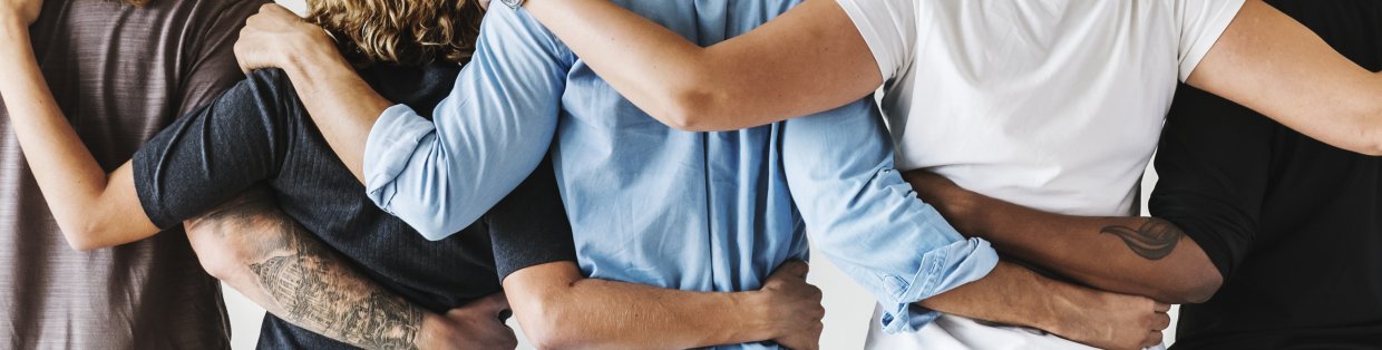 a diverse group of people hugging.