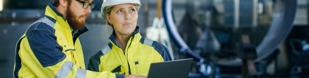 Occupational safety header featuring two workers in a hardhat and reflector vests. 
